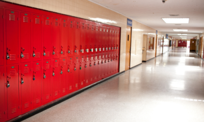 red lockers along high school hallway wall